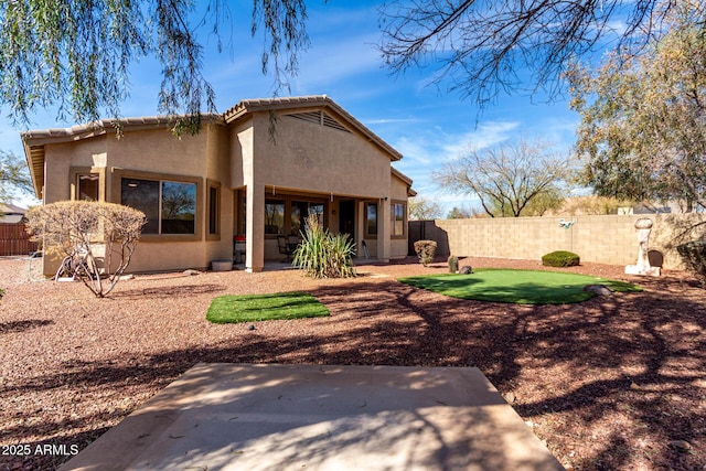 rear view of property with fence and stucco siding