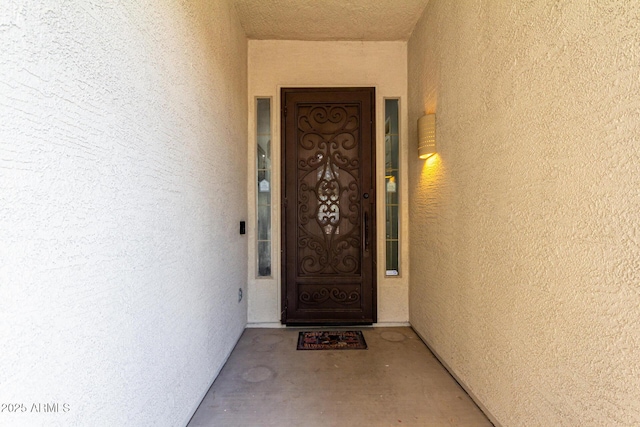 property entrance featuring stucco siding