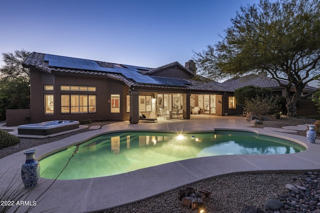 28897 N 94th Pl, Scottsdale, AZ 85262 - back of house with an outdoor hot tub, a tile roof, a patio, solar panels, and a chimney