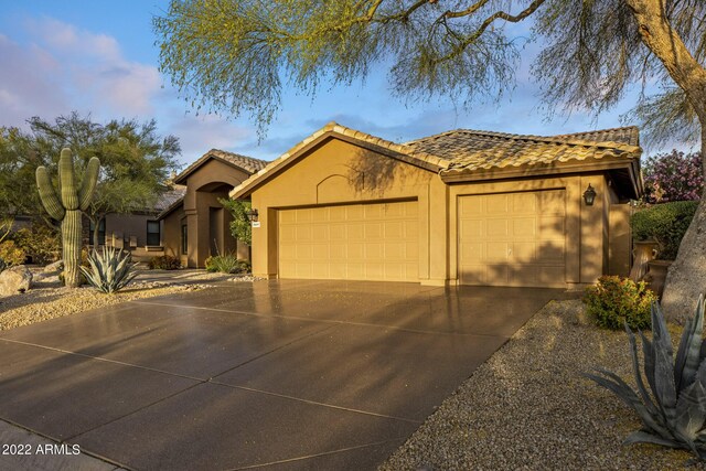 28897 N 94th Pl, Scottsdale, AZ 85262 - view of front of house featuring stucco siding, an attached garage, concrete driveway, and a tiled roof