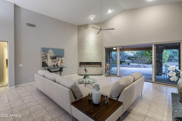 28897 N 94th Pl, Scottsdale, AZ 85262 - living room with high vaulted ceiling, a large fireplace, ceiling fan, baseboards, and light tile patterned floors