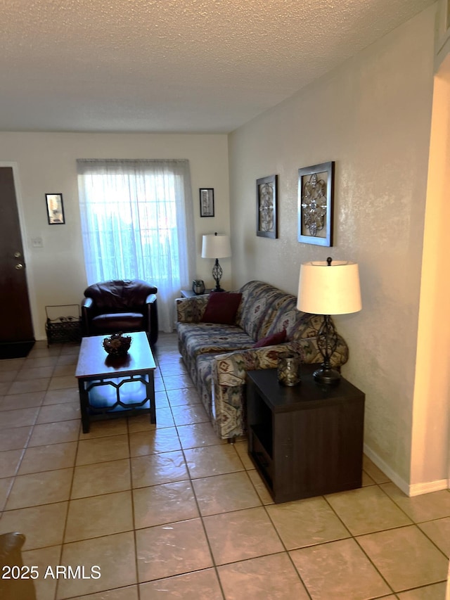 living room featuring light tile patterned flooring and a textured ceiling