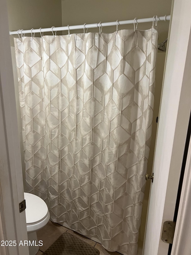 bathroom featuring tile patterned floors and toilet