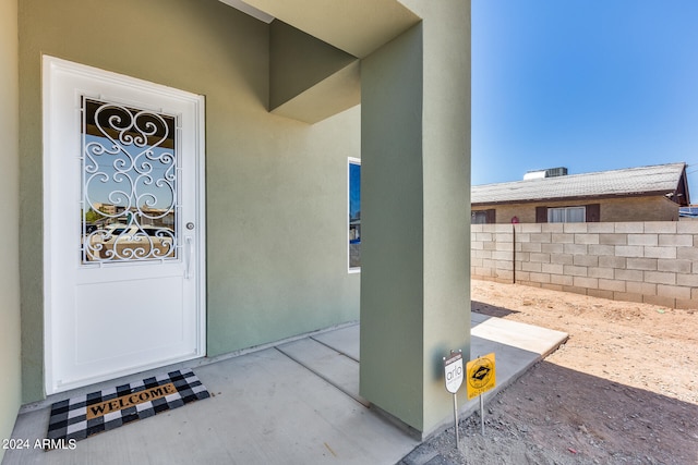 doorway to property with a patio area