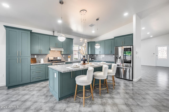 kitchen with a kitchen island, lofted ceiling, pendant lighting, and stainless steel appliances