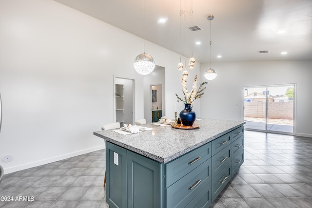 kitchen featuring light tile patterned floors, a center island, hanging light fixtures, and high vaulted ceiling