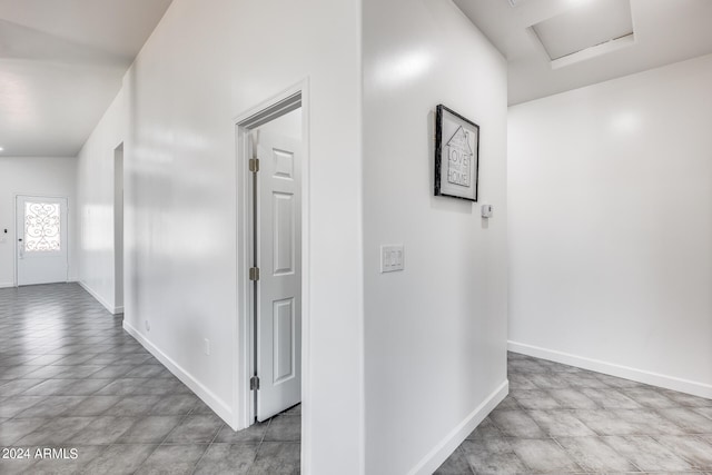 corridor featuring light tile patterned flooring