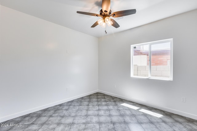 empty room featuring ceiling fan and tile patterned flooring