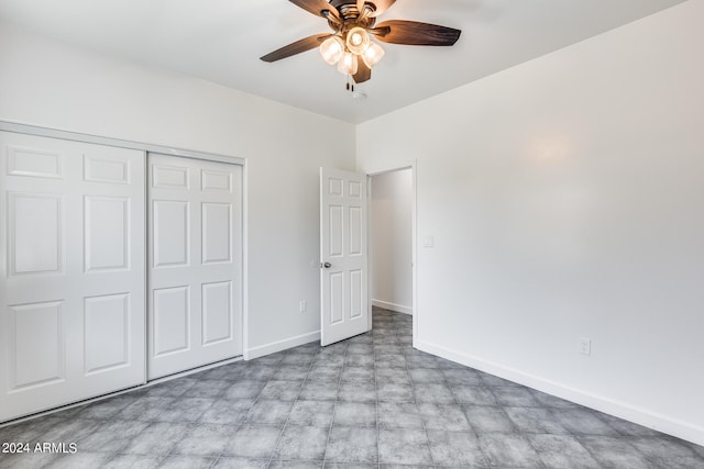 unfurnished bedroom featuring ceiling fan, light tile patterned flooring, and a closet