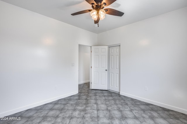 unfurnished room featuring ceiling fan and tile patterned flooring