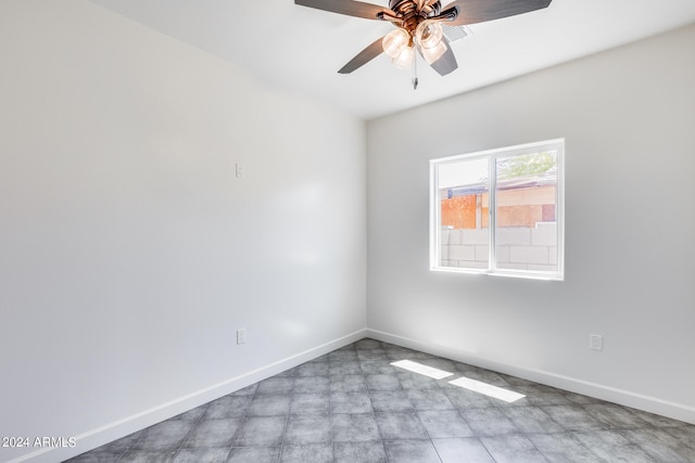 tiled spare room featuring ceiling fan