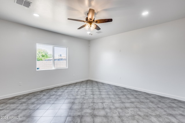 tiled spare room featuring ceiling fan