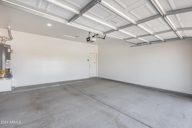 garage featuring a garage door opener and water heater