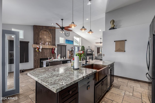 kitchen featuring sink, lofted ceiling, an island with sink, and appliances with stainless steel finishes