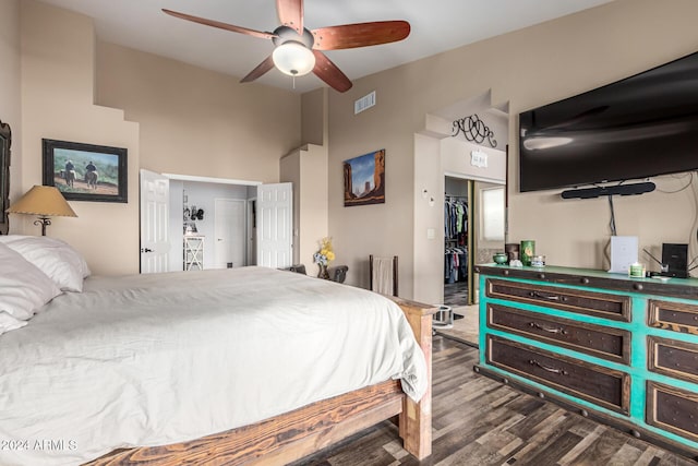 bedroom with ceiling fan, dark hardwood / wood-style flooring, and a closet