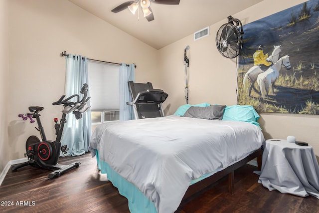 bedroom featuring dark hardwood / wood-style flooring, vaulted ceiling, and ceiling fan