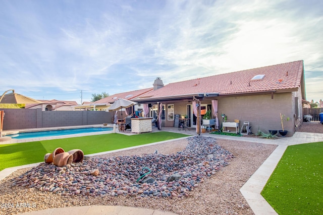 back of house with a patio area and a fenced in pool