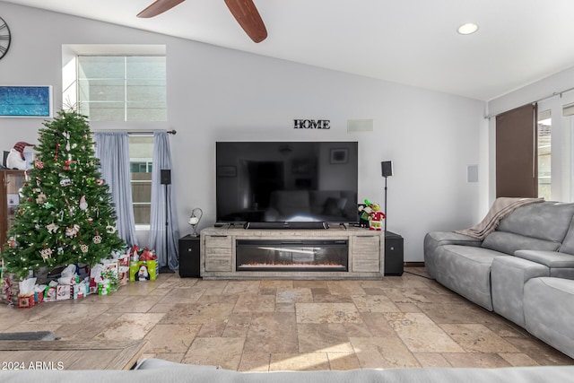 living room featuring ceiling fan and lofted ceiling