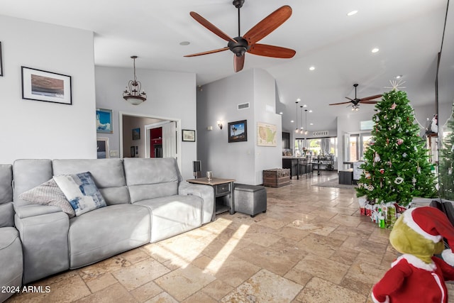 living room with ceiling fan and high vaulted ceiling