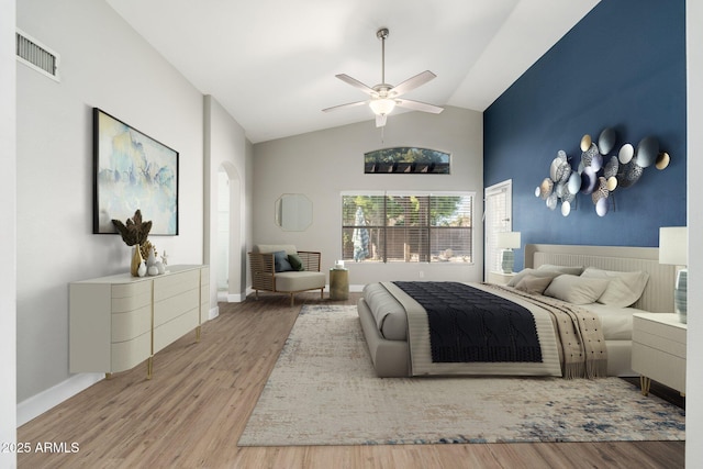 bedroom featuring wood-type flooring, high vaulted ceiling, and ceiling fan