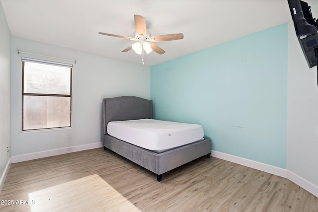 bedroom with ceiling fan and light wood-type flooring