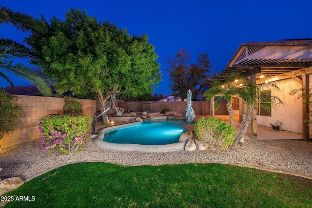 pool at twilight with a patio area