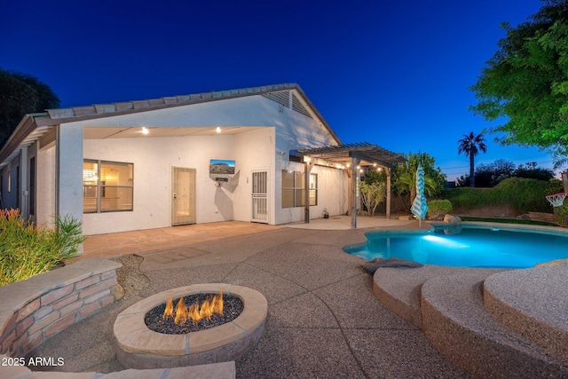 pool at twilight with a pergola, a patio area, and an outdoor fire pit