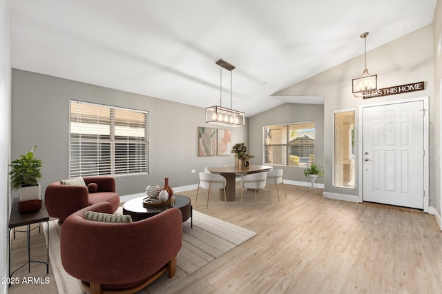 foyer with lofted ceiling and light hardwood / wood-style flooring