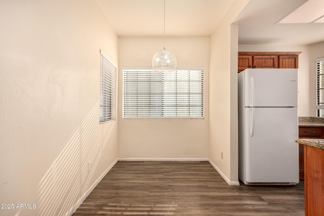 930 N Mesa Dr Unit 1023, Mesa, AZ 85201 - unfurnished dining area with baseboards and dark wood-style floors