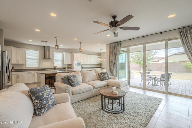 living room featuring a ceiling fan, light tile patterned flooring, recessed lighting, and visible vents