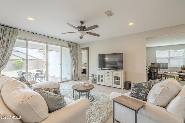 living area with a ceiling fan, recessed lighting, and visible vents