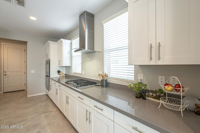 kitchen with visible vents, white cabinets, ventilation hood, and stainless steel gas stovetop