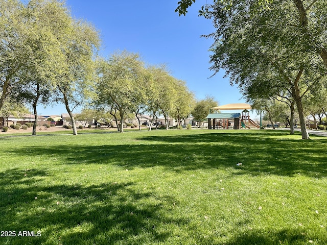 surrounding community featuring playground community and a yard