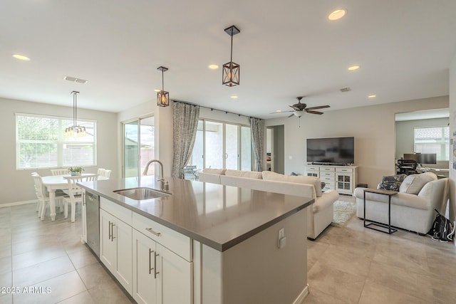 kitchen featuring open floor plan, dishwasher, recessed lighting, plenty of natural light, and a sink