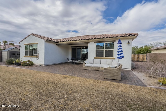 back of property featuring a patio, fence, stucco siding, outdoor lounge area, and a tile roof