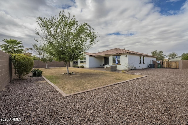 back of house with stucco siding, a patio area, a fenced backyard, and a tile roof