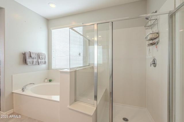 full bathroom with a garden tub and a shower stall