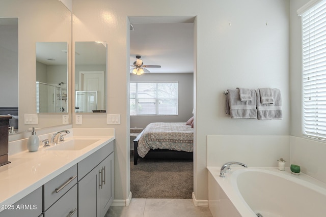 ensuite bathroom featuring a garden tub, a stall shower, a ceiling fan, ensuite bath, and vanity