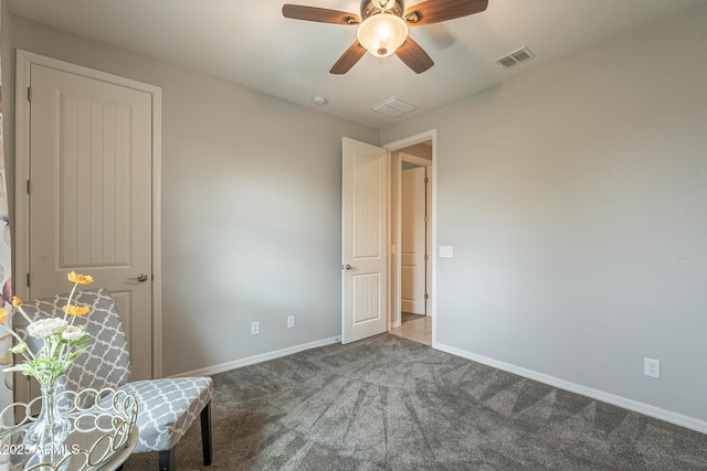 unfurnished room with ceiling fan, carpet, visible vents, and baseboards