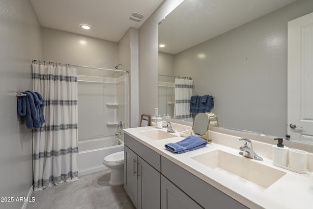 bathroom featuring double vanity, toilet, shower / bath combo, and a sink