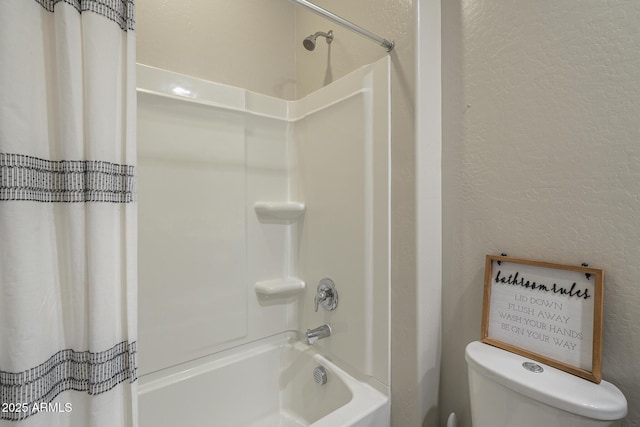 full bathroom with shower / bathtub combination with curtain, toilet, and a textured wall