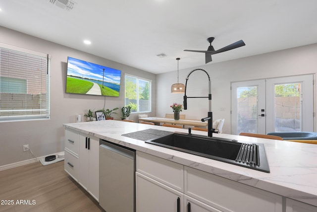5439 W Odeum Ln, Phoenix, AZ 85043 - kitchen featuring stainless steel dishwasher, french doors, white cabinetry, light wood-type flooring, and hanging light fixtures
