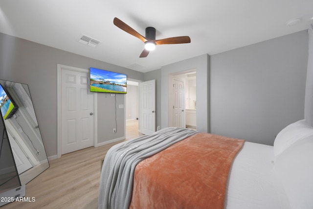 5439 W Odeum Ln, Phoenix, AZ 85043 - bedroom with light wood finished floors, a ceiling fan, and ensuite bath
