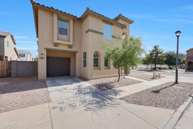 5439 W Odeum Ln, Phoenix, AZ 85043 - view of front of home featuring stucco siding, an attached garage, driveway, and a tiled roof