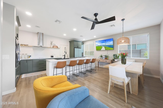5439 W Odeum Ln, Phoenix, AZ 85043 - kitchen featuring freestanding refrigerator, light wood-style floors, a ceiling fan, healthy amount of natural light, and recessed lighting