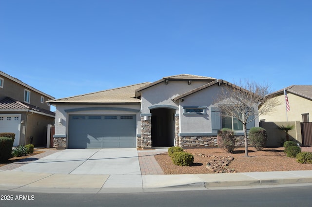 view of front of property with a garage, fence, stone siding, concrete driveway, and stucco siding