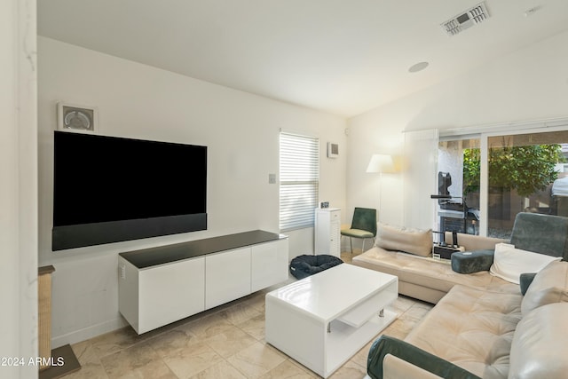 living room featuring a wealth of natural light and vaulted ceiling