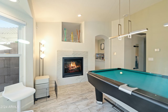 game room with a high end fireplace and pool table