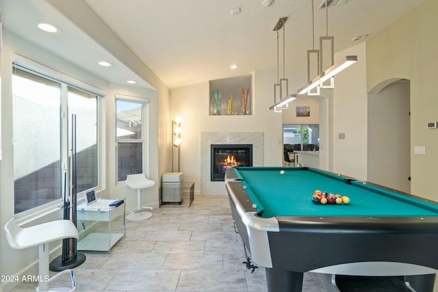 recreation room featuring a fireplace, light tile patterned floors, lofted ceiling, and pool table