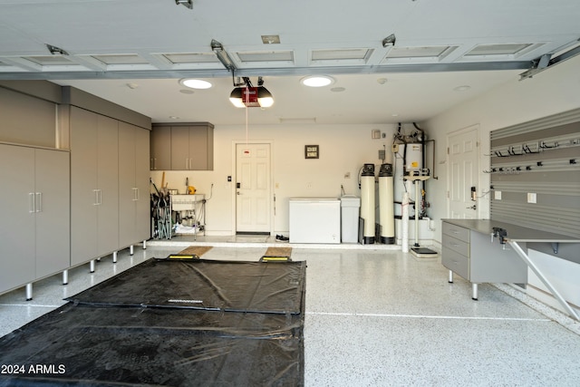 garage with a garage door opener and white refrigerator